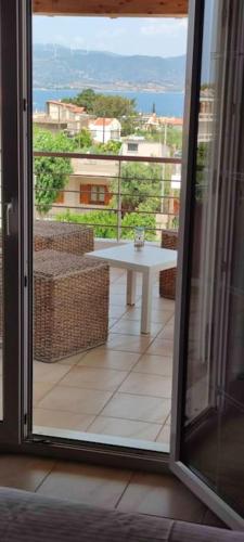 a sliding glass door to a balcony with a table at Villa Demy in Patra