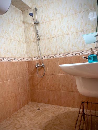 a bathroom with a shower and a sink at First Sea Line Apartment FLORA, next to the beach in Pomorie