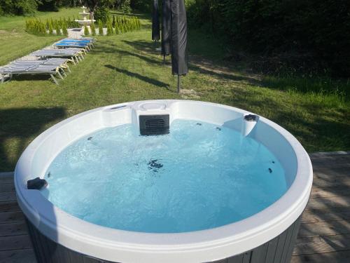 a jacuzzi tub in a yard with chaise at Vera Park & Wellness in Belluno