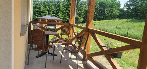 a porch with chairs and a gazebo at Zajazd Stronie in Stronie Śląskie