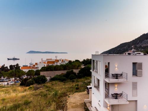 a white building with a view of the water at Seaside Elegance Suites in Komiža