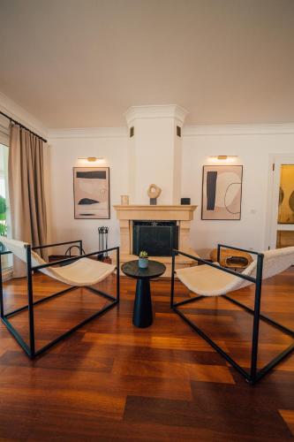 a living room with two chairs and a fireplace at Terra House Sapanca in Sapanca