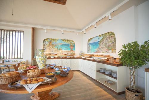a large kitchen with a table with food on it at Datça Dirik Surf Beach Hotel in Datca