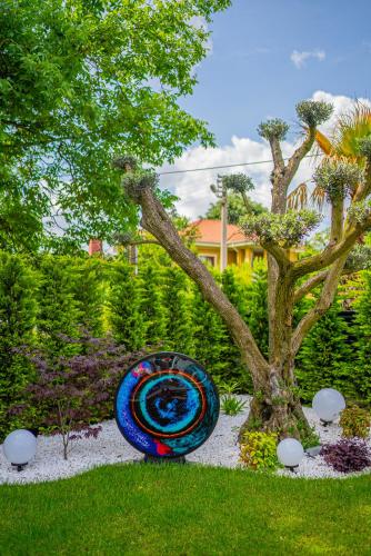 a sculpture in the grass next to a tree at Terra House Sapanca in Sapanca