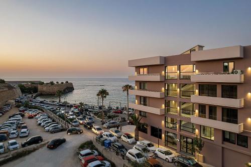 a parking lot in front of a building with cars parked at Theta Boutique Hotel in Chania