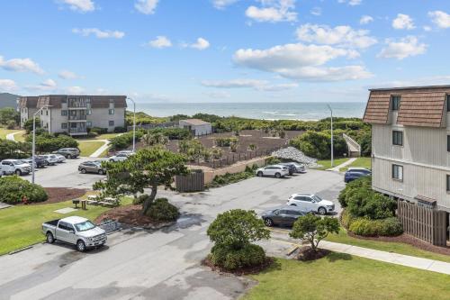 an aerial view of a parking lot with cars parked at Southwinds, Unit H13 in Atlantic Beach