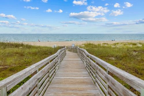 a wooden boardwalk leading to a beach with the ocean at Southwinds, Unit H13 in Atlantic Beach