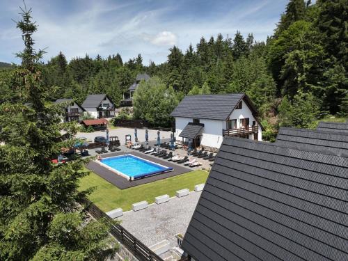 an aerial view of a house with a swimming pool at A Frame Chalet By Superski in Cavnic