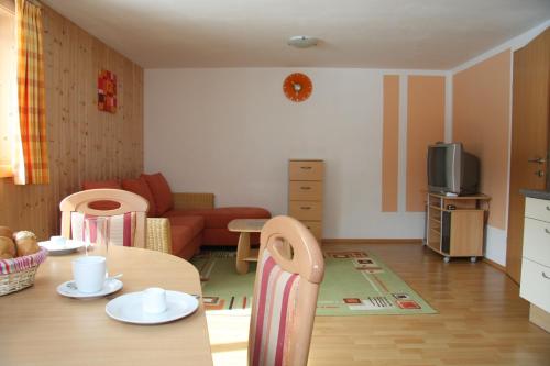 a living room with a table and a couch at Haus Lutea in Gaschurn