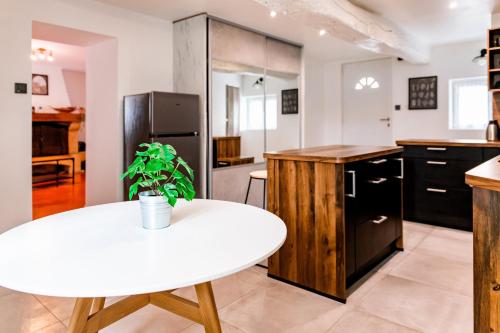 a kitchen with a white table and a refrigerator at EVA in Serris