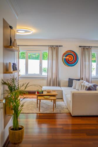 a living room with a white couch and a table at Terra House Sapanca in Sapanca