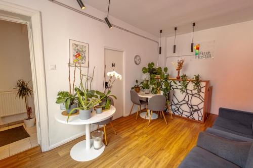 a living room filled with lots of potted plants at First Hostel in Bucharest