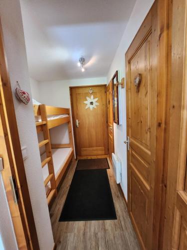 a hallway with a bunk bed and a door at Cocon à chatel in Châtel