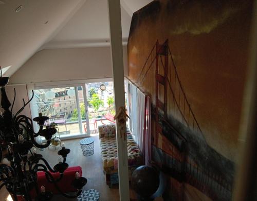 a living room with a large painting of a train on the wall at Loft la plus belle vue du lac Léman Montreux in Montreux