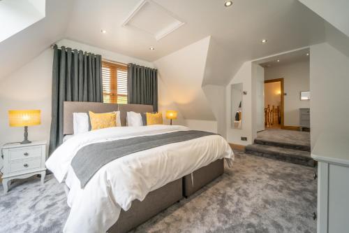 a bedroom with a large bed and a window at The Hoose at The Vu in Bathgate