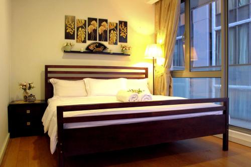 a bedroom with a large bed with a window at D'CASA Bintang Fairlane at Bukit Bintang in Kuala Lumpur