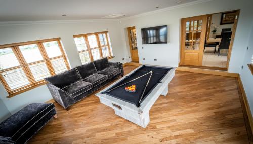 a living room with a couch and a fireplace at The Hoose at The Vu in Bathgate