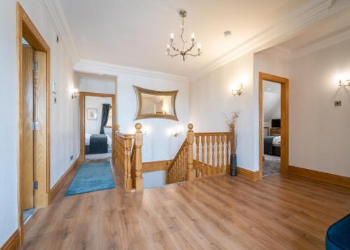 a living room with a staircase and a hallway with a room with at The Hoose at The Vu in Bathgate