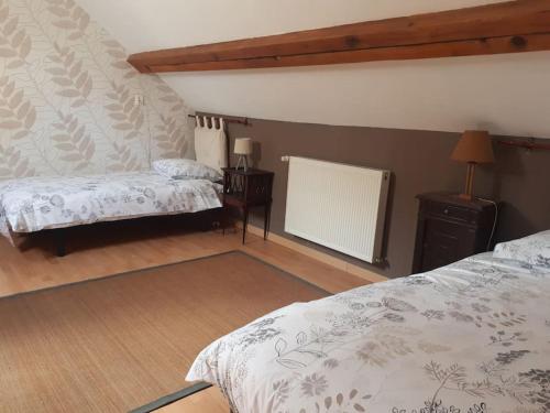 - une chambre avec 2 lits et un bureau avec une lampe dans l'établissement La maison de Nestalas, à Pierrefitte-Nestalas