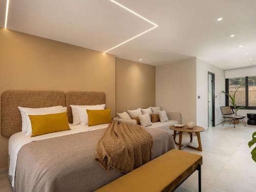 a bedroom with two beds with yellow and white pillows at Theta Boutique Hotel in Chania
