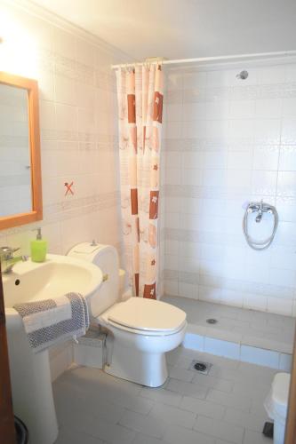 a bathroom with a toilet and a sink and a shower at Elegant Maisonettes Elena in Nea Potidaea