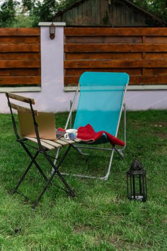 a chair with a laptop sitting in the grass at Nomad Sud Studios in Town Center in Cahul