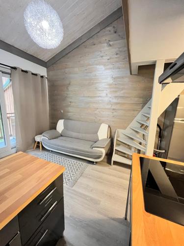 a living room with a staircase and a couch at Le Petit Chalet Addicted to Paradise in Tignes