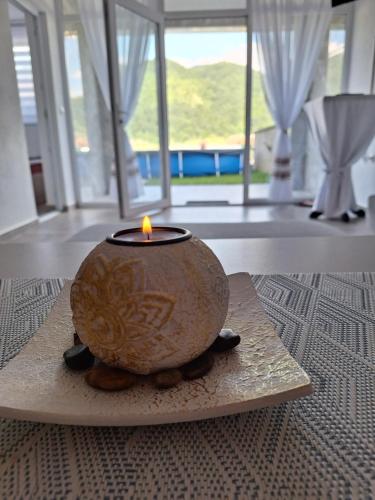 a candle sitting on a plate on a table at Vila Gavrić in Zvornik