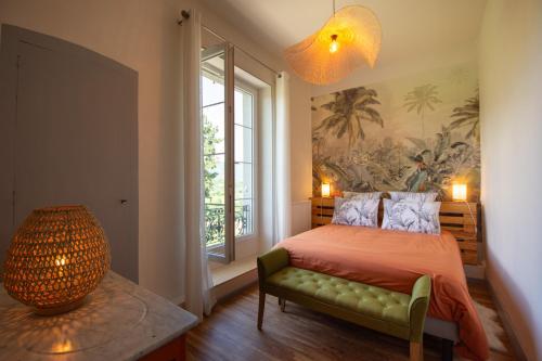 a bedroom with a bed and a large window at Domaine des Granges Longes in Les Marches
