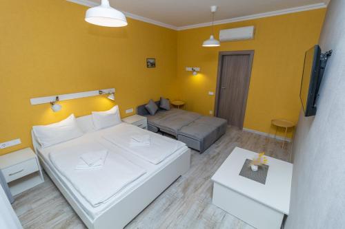 a living room with a bed and a couch at Opera Passage Hotel & Apartments in Lviv