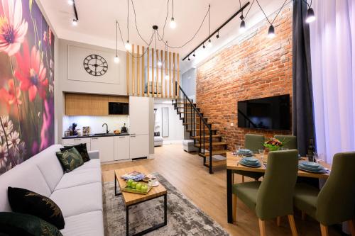 salon z białą kanapą i ceglaną ścianą w obiekcie Arts Apartments - Kraków Old Town w Krakowie