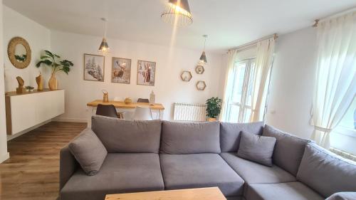 a living room with a couch and a table at VUT Sierra Pambley in Villablino