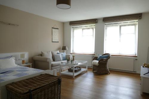 a bedroom with a bed and a couch and a table at Hotel Ratsstuben in Lindau
