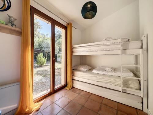 a bedroom with two bunk beds and a window at VILLA DU VERDON VAR PROVENCE avec piscine et jardin - private in Régusse