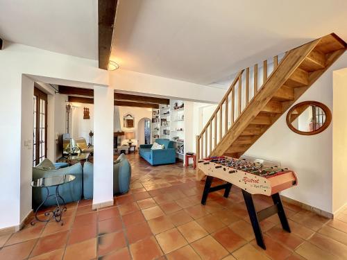 a living room with a foosball table and stairs at VILLA DU VERDON VAR PROVENCE avec piscine et jardin - private in Régusse