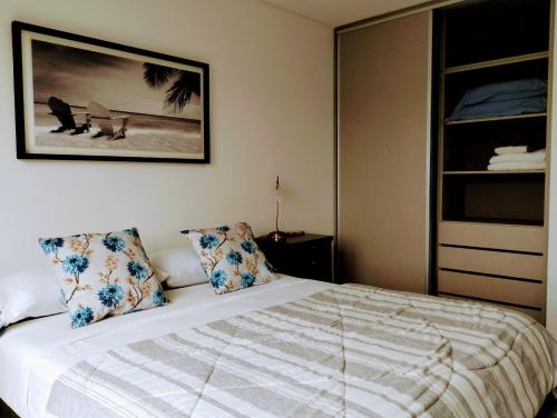 a bedroom with a bed with two pillows at 304 San Lorenzo in Mar del Plata