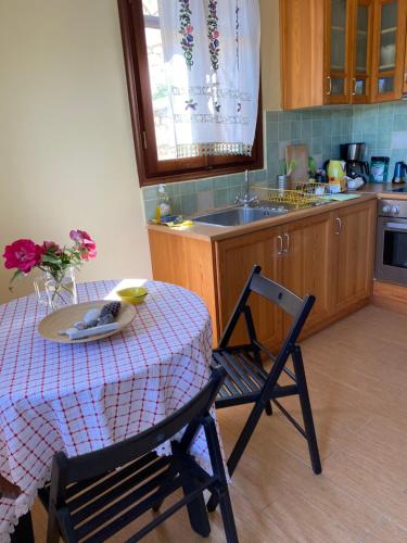 a kitchen with a table and a chair and a sink at Lemontree2 in Agios Nikitas