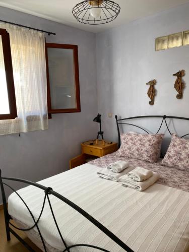a bedroom with a bed with two towels on it at Lemontree2 in Agios Nikitas