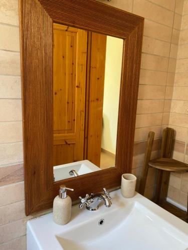 a bathroom sink with a large mirror above it at Lemontree2 in Agios Nikitas