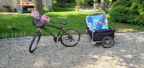 a bike parked next to a chair and a stroller at The Platinum Pebble Boutique Inn - Adults Only Property in Harwich Port