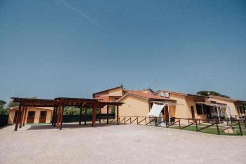 a building with a pavilion in front of it at I SEE LAKE in Castiglione del Lago