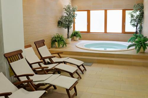 a room with chairs and a swimming pool at Aparthotel Snjezna Kraljica in Zagreb