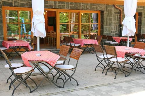 a group of tables and chairs with pink tables at Aparthotel Snjezna Kraljica in Zagreb