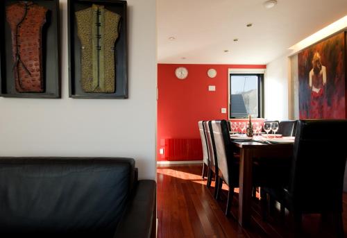 a dining room with a table and black chairs at Udelka A in Niseko