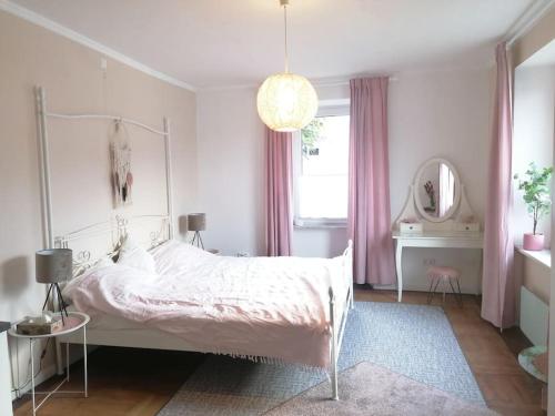 a bedroom with a white bed and a mirror at Voll ausgestattete Wohnung mit Moselblick in Alf