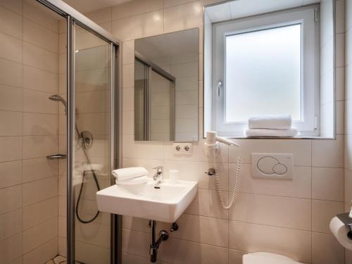 a bathroom with a sink and a shower at Appartements Pungg in Fügen