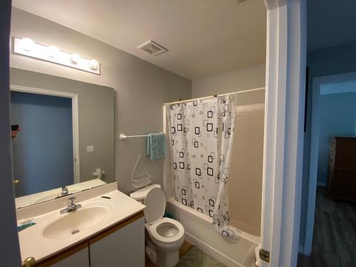 a bathroom with a sink and a toilet and a shower at 2 private rooms in a quiet neighborhood can book up to 4 people in Orlando
