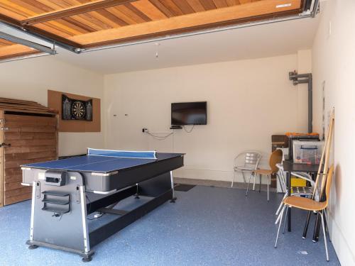 a ping pong table in a room with chairs at Snowmass Lodge - hot tub in Aviemore in Aviemore
