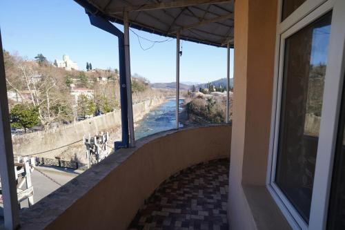 a room with a view of a river from a building at imperator 1 Hotel in Kutaisi