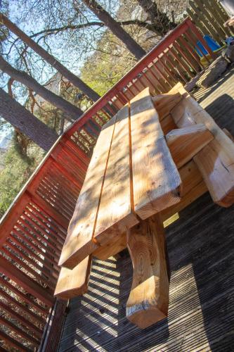 a wooden bench sitting on top of a parkbench at The Shieling in Aviemore